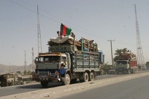 Afghan refugees traveling in a truck back to Afghanistan in 2004 Photo: USAID via Wikimedia Commons 