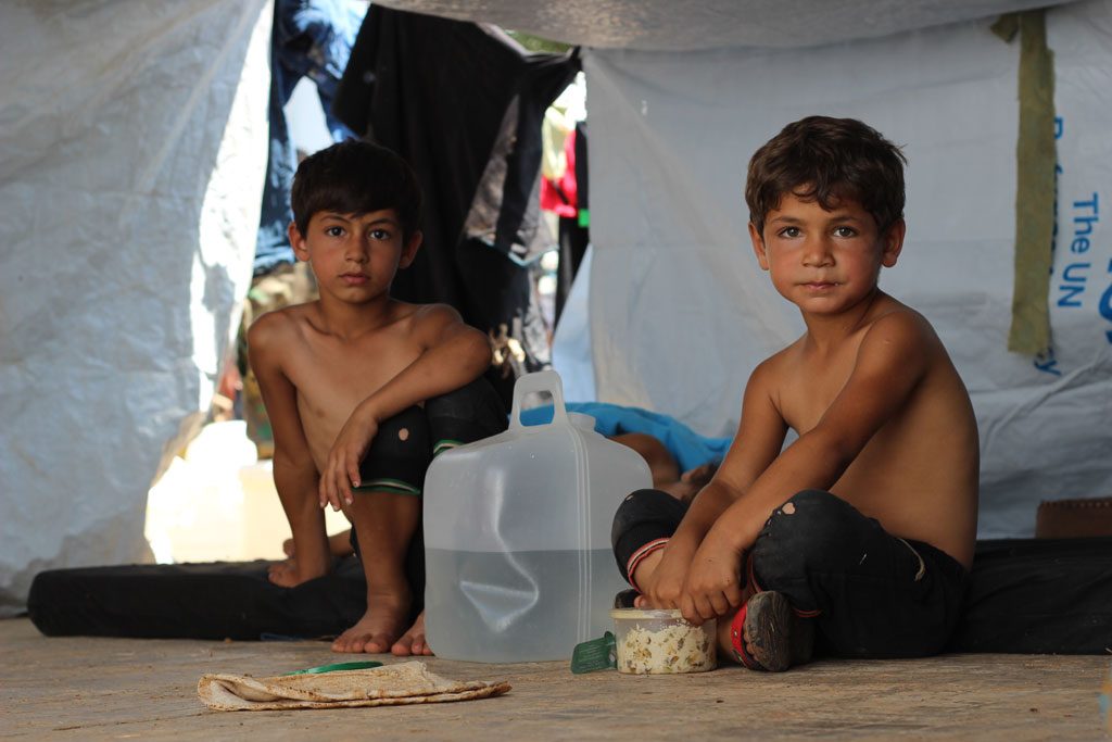 Children displaced from ongoing conflict shelter under makeshift tents on Muhalak highway in the western part of Aleppo, Syria. Photo: UNICEF/Khuder Al-Issa