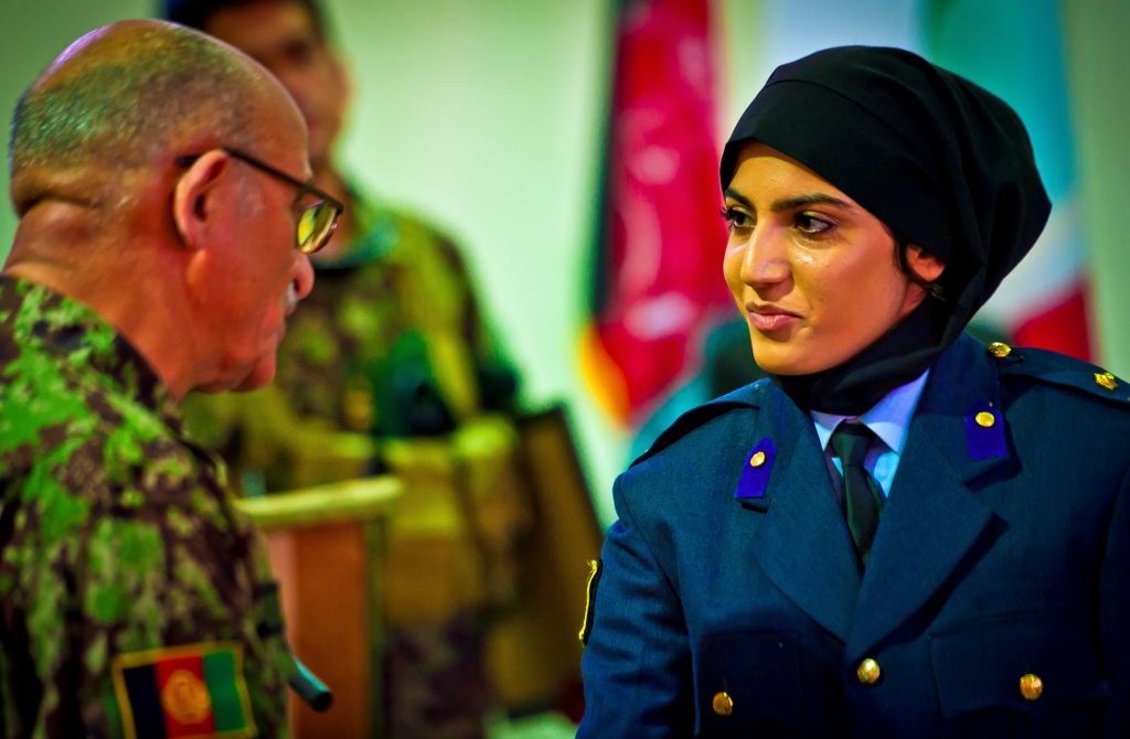 Afghan air force 2nd Lt. Niloofar Rhmani accepts her pilot wings at a ceremony May 14, 2013, at Shindand Air Base, Afghanistan, as she graduates undergraduate pilot training. Rhmani made history May 14, 2013, when she became the first female to successfully complete undergraduate pilot training and earn the status of pilot in more than 30 years. She will continue her service as she joins the Kabul Air Wing as a Cessna 208 pilot. (U.S. Air Force photo/ Senior Airman Scott Saldukas)