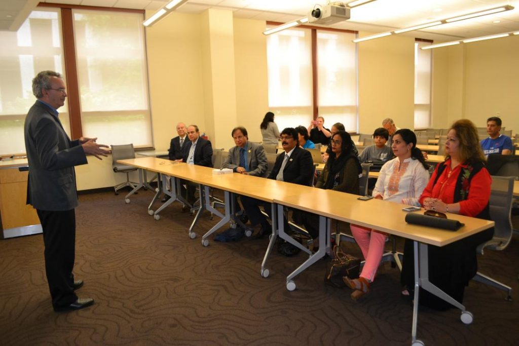 Then-School of International Service Dean James Goldgeier welcomes the Cholistan Development Council to American University for a luncheon honoring them for their work on July 12, 2017. Author Ambassador Akbar Ahmed is seated at the far left of the first row. 