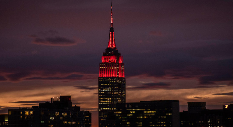 The Empire State Building was lit in red, pictured here from UN Headquarters in Midtown Manhattan, to pay tribute to first responders who are on the front line of the response to the pandemic. UN Photo/Evan Schneider